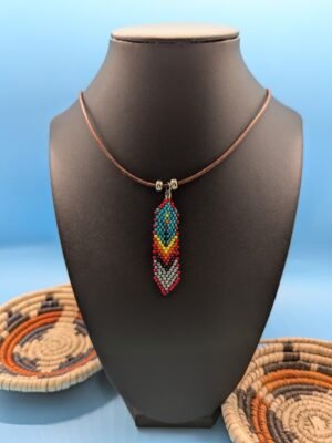 Cinder Sky Hand beaded feather necklace, Cinder Sky, turquoise top with red edging and silver-grey chevrons, sterling silver accents on leather.