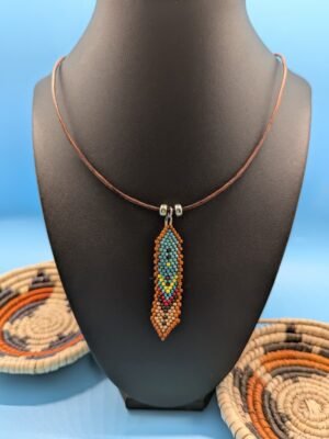 Sage & Clay Hand beaded feather necklace, Sage and Clay, muted turquoise and earth tones with tan edging, sterling silver accents on leather.